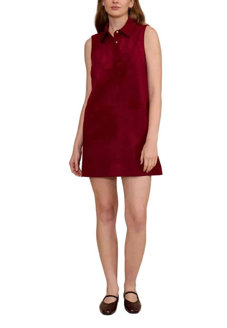 Woman wearing a red sleeveless dress against a beige background