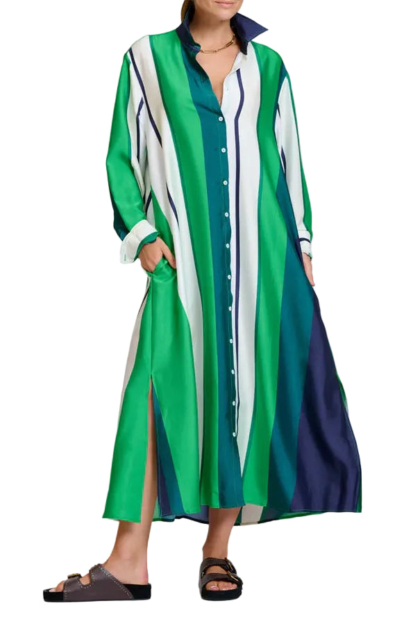 Woman wearing a long, green and white striped dress with a white background