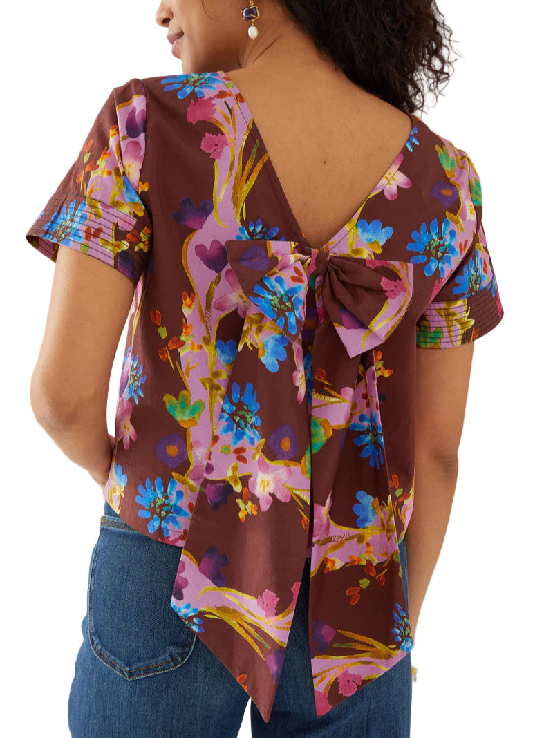This charming top features a contrast print trim at the sleeve and a delicate bow at the back.