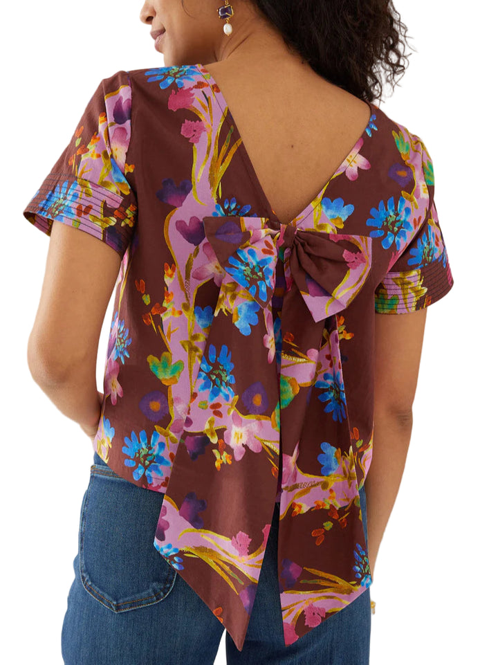 This charming top features a contrast print trim at the sleeve and a delicate bow at the back.