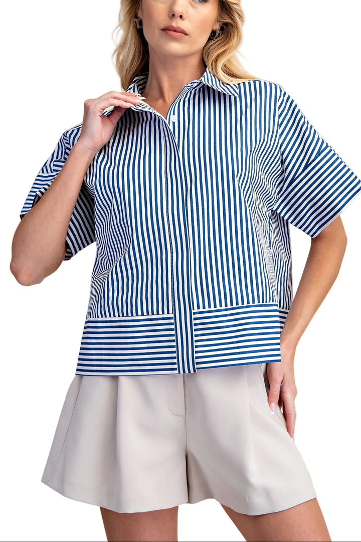 The Martha Blue Stripe Top combines classic style with everyday comfort. This neck band short sleeve button down features crisp blue stripes on a versatile base, perfect for layering or wearing solo. The structured neckline and button front closure offer a polished look, while the relaxed short sleeves keep you cool and comfortable. Ideal for casual outings, work settings, or weekend wear. A timeless piece that pairs effortlessly with jeans, skirts, or trousers.