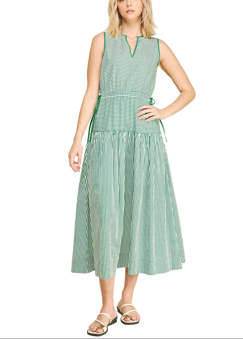 The Martha Striped Midi Dress combines timeless style with effortless versatility. This sleeveless V-neck design features classic stripes in a flattering midi length, perfect for layering or wearing solo. The relaxed silhouette works seamlessly from casual daytime looks to dressed-up evening occasions. Pair with sandals and a light cardigan for spring, or add heels and a blazer for a polished finish. A wardrobe essential that transitions beautifully across seasons.