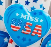 Basket with patriotic-themed items including bracelets and a keychain on a white background