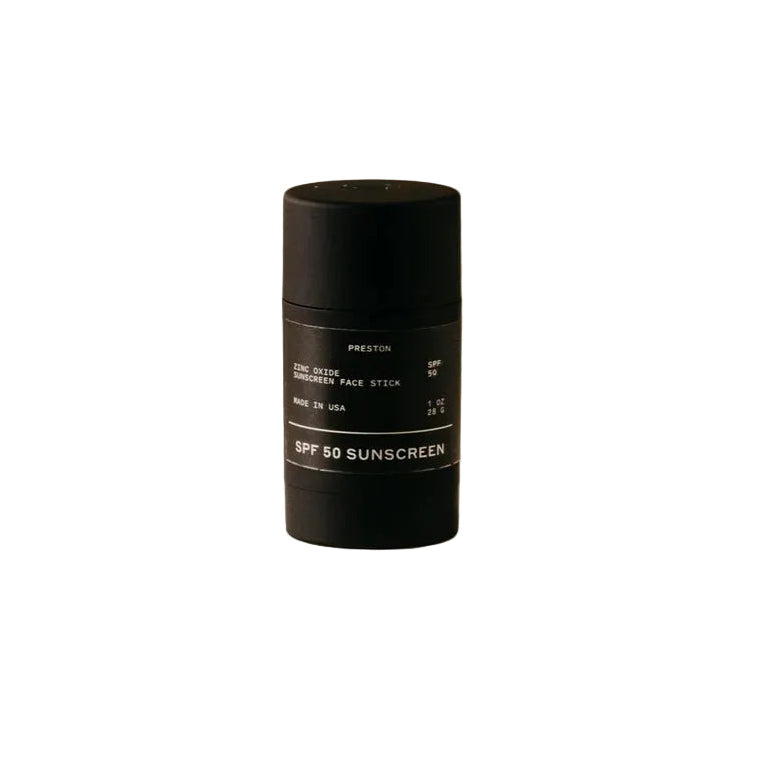 Black sunscreen stick on a beige background