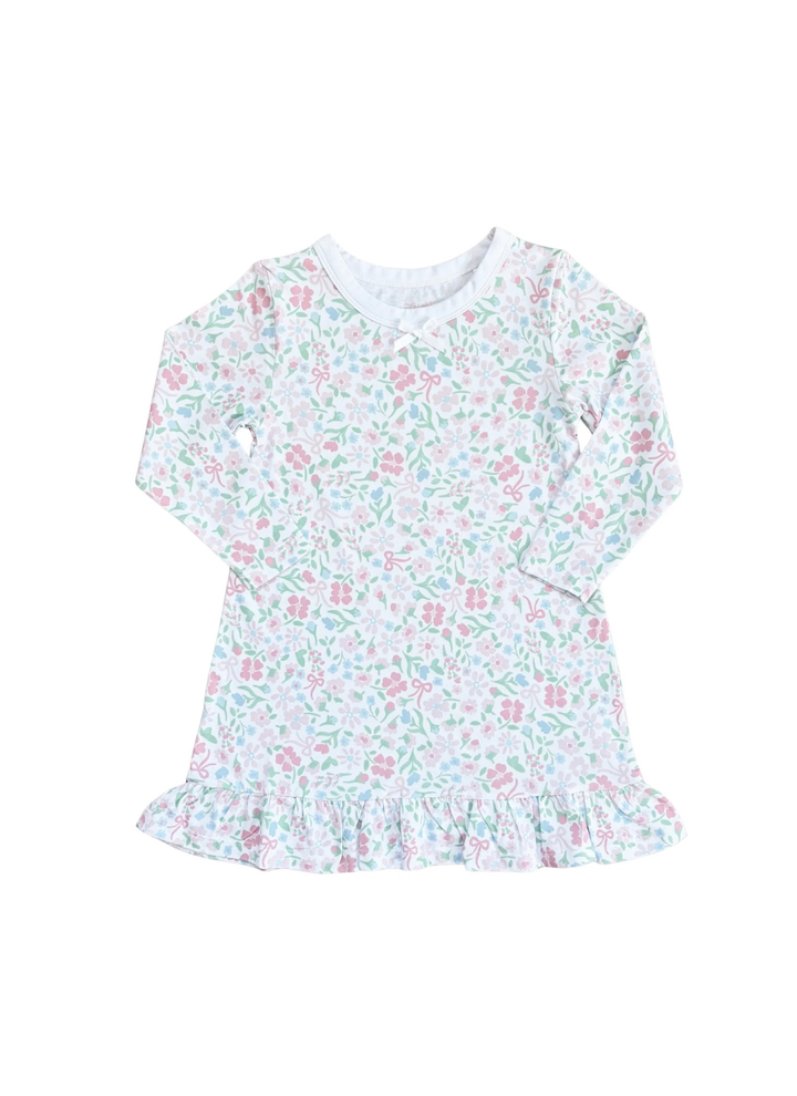 A long-sleeve baby dress with a delicate pink and green floral pattern on a white background, featuring a ruffled hem and a ruffled neckline.