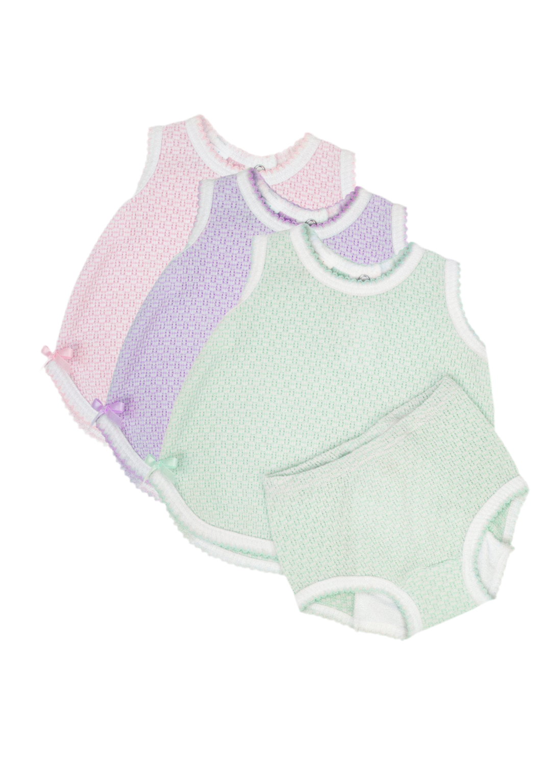 Three pastel-colored baby bodysuit sets stacked together on a white background. The sets are light green, lavender purple, and light pink, each featuring a textured knit fabric, white ruffled trim, and small bow accents.