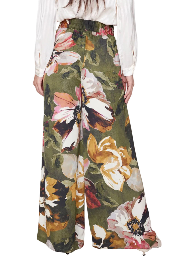 Floral patterned pants worn by a person on a white background