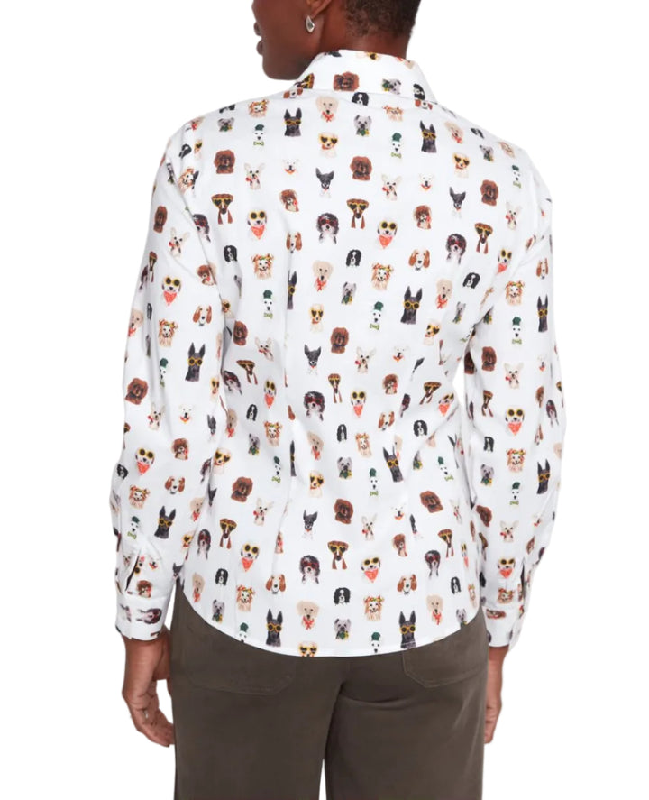 Person wearing a white shirt with dog pattern on a plain background