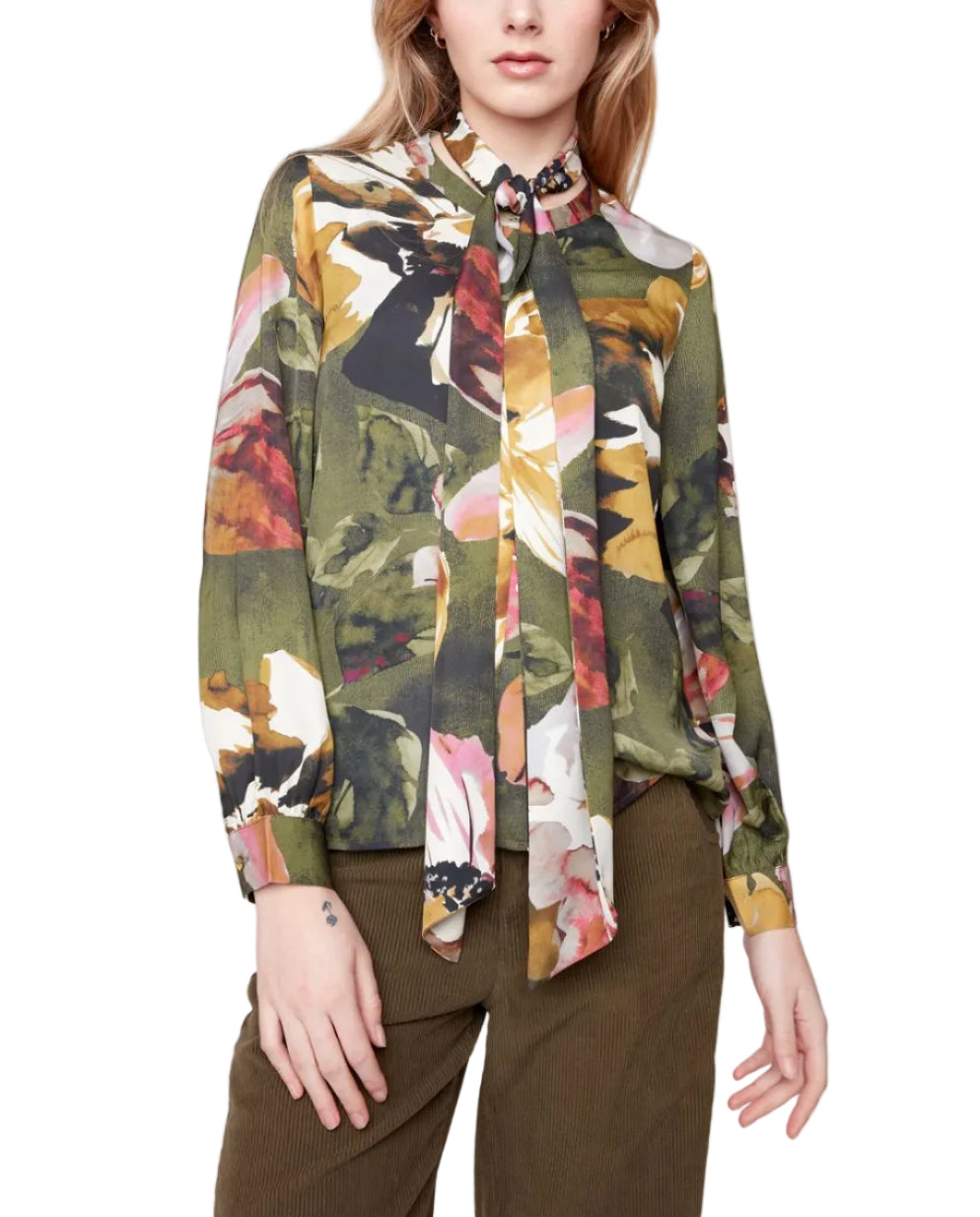 Woman wearing a colorful floral blouse with a plain background