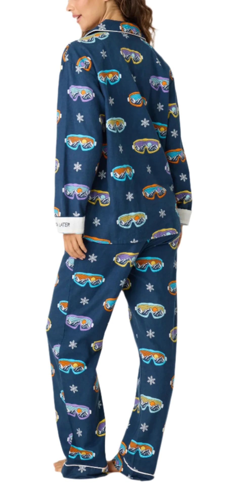 Hit the slopes of comfort with our 100% cotton flannel pajama set, featuring a fun navy and multi ski-goggle print. This playful set includes a button front collared top and tie waist pants, combining warmth with cozy style. The embroidered sleeve cuffs read “Ski You Later,” adding a whimsical touch to your look. Complete with a matching hair wrap, this set is perfect for cozy nights in or après-ski relaxation.