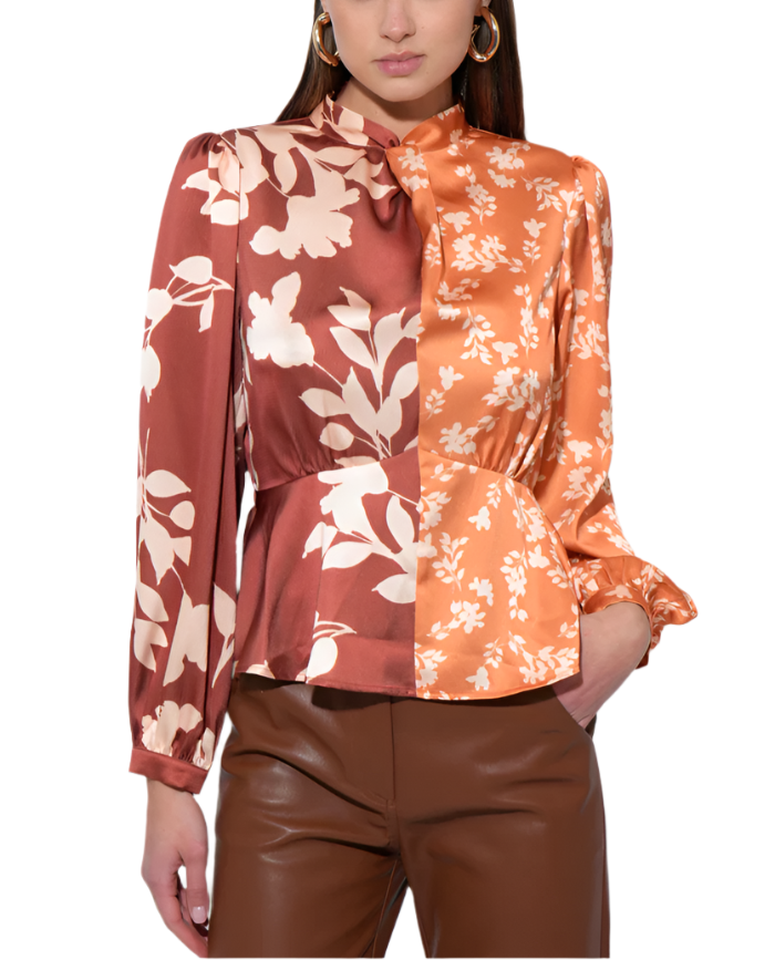 Brighten your wardrobe with the Ruiza Two Tone Mock Neck Blouse in Marigold and Brown. This playful blouse pairs a cheerful marigold hue with warm brown accents, creating a fun and stylish contrast.