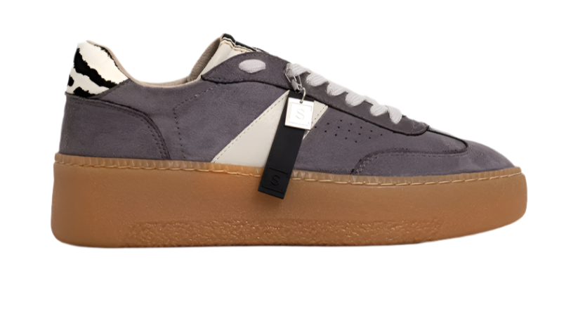 Bold. Casual. Elevated. The STACEY in Grey Suede redefines off-duty cool with its sleek silhouette, contrast details, and chunky sole. Crafted from soft faux suede in a deep grey tone, this sneaker features a cream panel, zebra-print heel tab, and a caramel-toned platform sole that adds subtle height. Whether you're running errands or stepping out for brunch, this pair delivers all-day comfort with a fashion-forward edge.