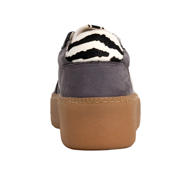 Bold. Casual. Elevated. The STACEY in Grey Suede redefines off-duty cool with its sleek silhouette, contrast details, and chunky sole. Crafted from soft faux suede in a deep grey tone, this sneaker features a cream panel, zebra-print heel tab, and a caramel-toned platform sole that adds subtle height. Whether you're running errands or stepping out for brunch, this pair delivers all-day comfort with a fashion-forward edge.