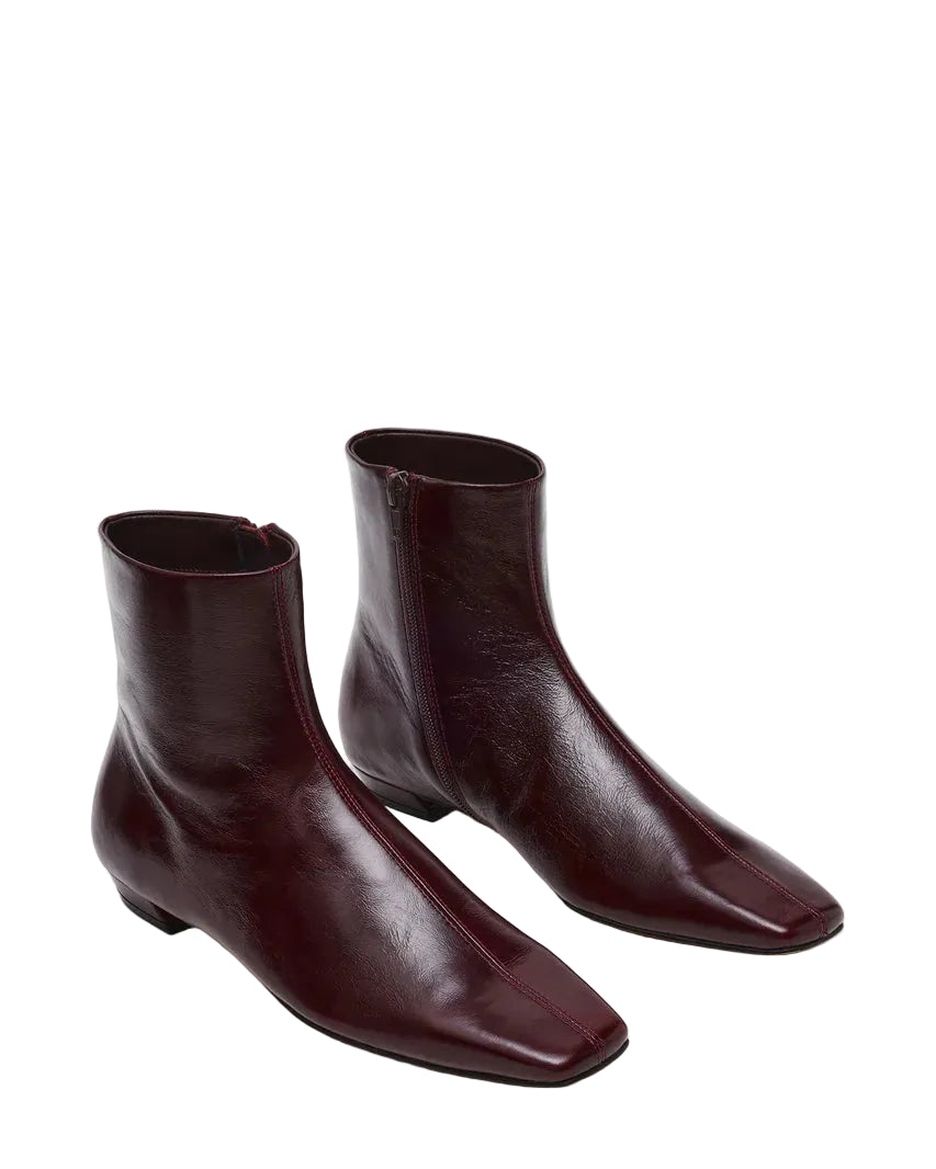 The ZAMI DARK CHERRY LEATHER is a versatile ankle bootie featuring a modern square toe silhouette that adds contemporary edge to any outfit. Crafted in premium materials, this bootie delivers comfort and sophistication for everyday wear or elevated occasions. The sleek ankle height and refined construction make it an essential addition to your footwear collection.

.75 inch heel height
10.25 inch shaft circumference
5.75 inch shaft height
Leather upper material
Textile lining
Vegan leather sock
