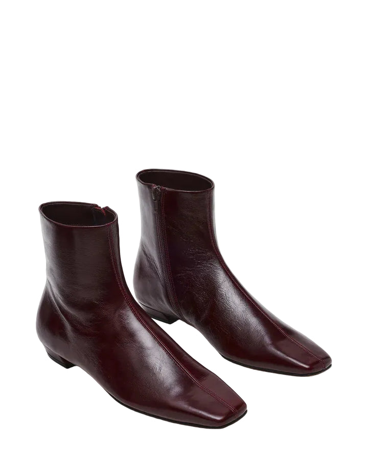 The ZAMI DARK CHERRY LEATHER is a versatile ankle bootie featuring a modern square toe silhouette that adds contemporary edge to any outfit. Crafted in premium materials, this bootie delivers comfort and sophistication for everyday wear or elevated occasions. The sleek ankle height and refined construction make it an essential addition to your footwear collection.

.75 inch heel height
10.25 inch shaft circumference
5.75 inch shaft height
Leather upper material
Textile lining
Vegan leather sock
