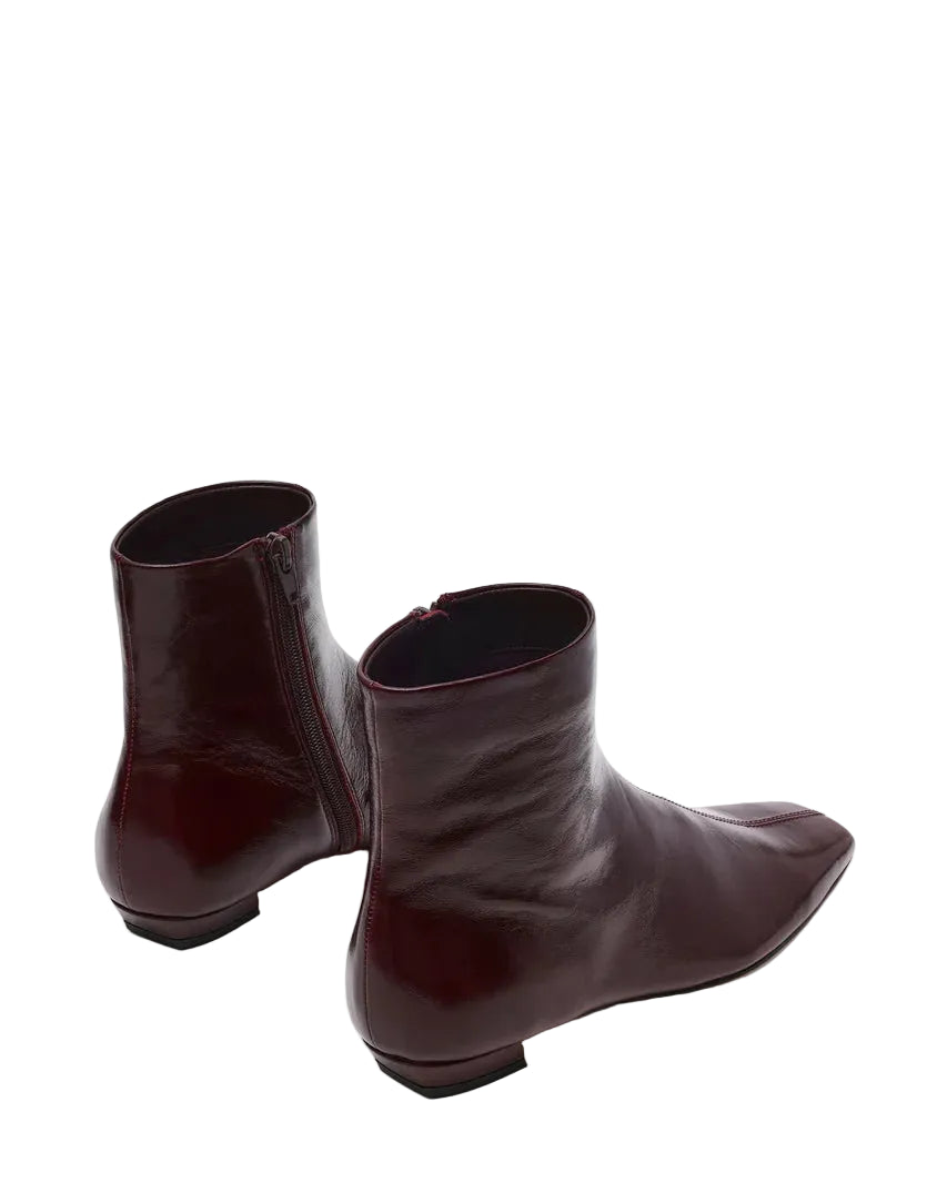 The ZAMI DARK CHERRY LEATHER is a versatile ankle bootie featuring a modern square toe silhouette that adds contemporary edge to any outfit. Crafted in premium materials, this bootie delivers comfort and sophistication for everyday wear or elevated occasions. The sleek ankle height and refined construction make it an essential addition to your footwear collection.

.75 inch heel height
10.25 inch shaft circumference
5.75 inch shaft height
Leather upper material
Textile lining
Vegan leather sock
