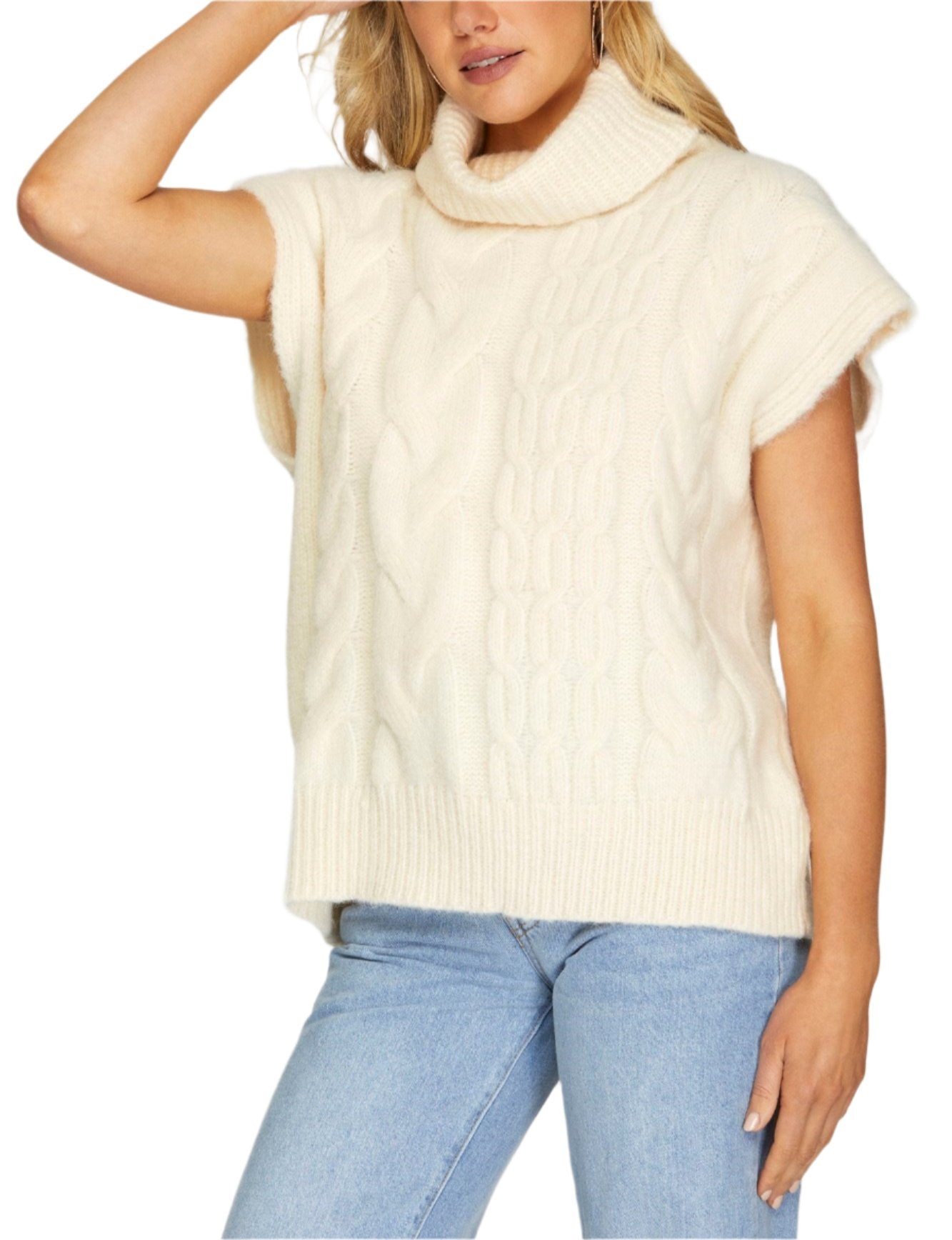 Drop shoulder, sleeveless turtleneck sweater.