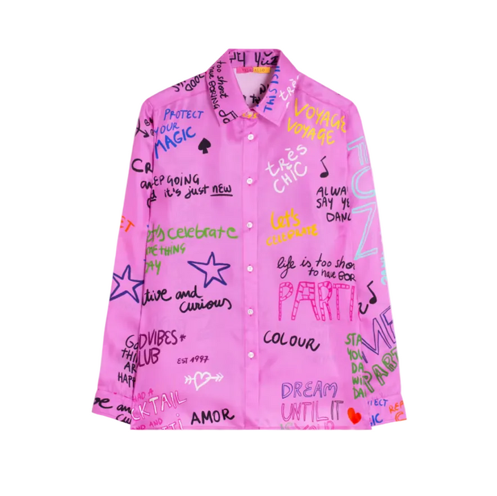 A bright pink button-up shirt covered in colorful graffiti-style text, stars, and doodles, shown flat against a light gray background.