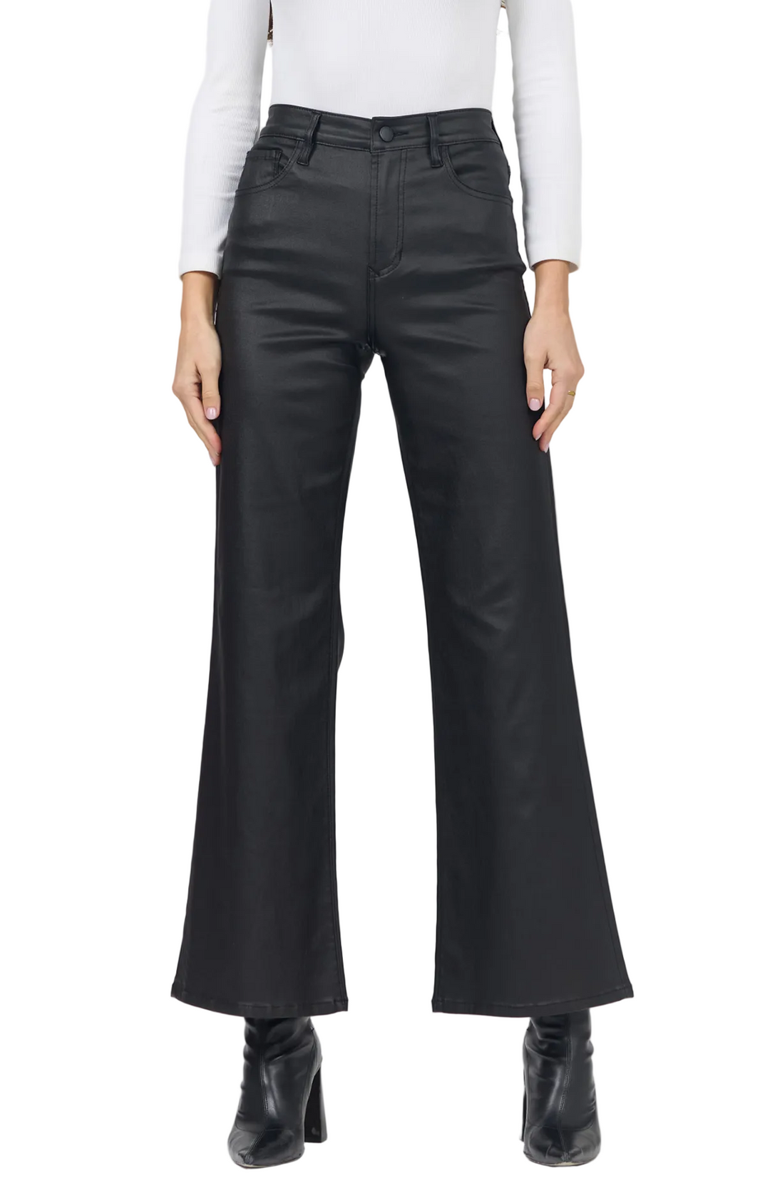 A model wearing black wide-leg flare pants, styled with a white long-sleeve top and black ankle boots, shown from the waist down on a light gray studio background.