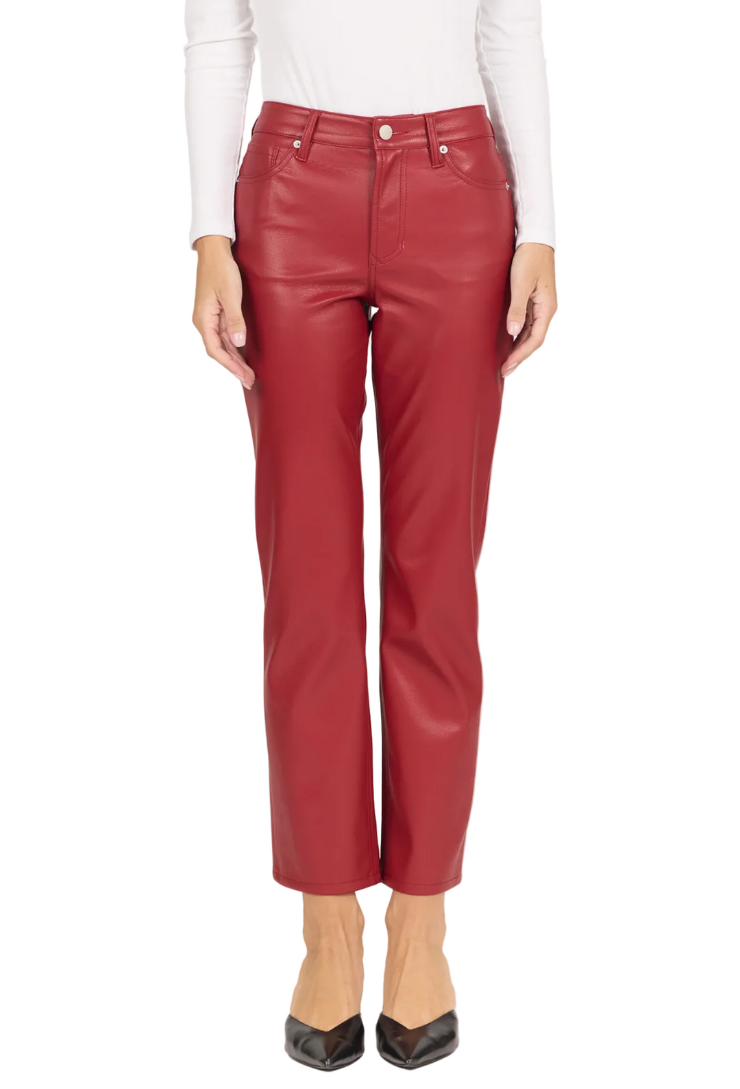 A model wearing a pair of high-waisted, straight-leg cropped pants in a reddish-brown faux leather material, styled with a white long-sleeve top and black pointed-toe heels against a plain off-white background.