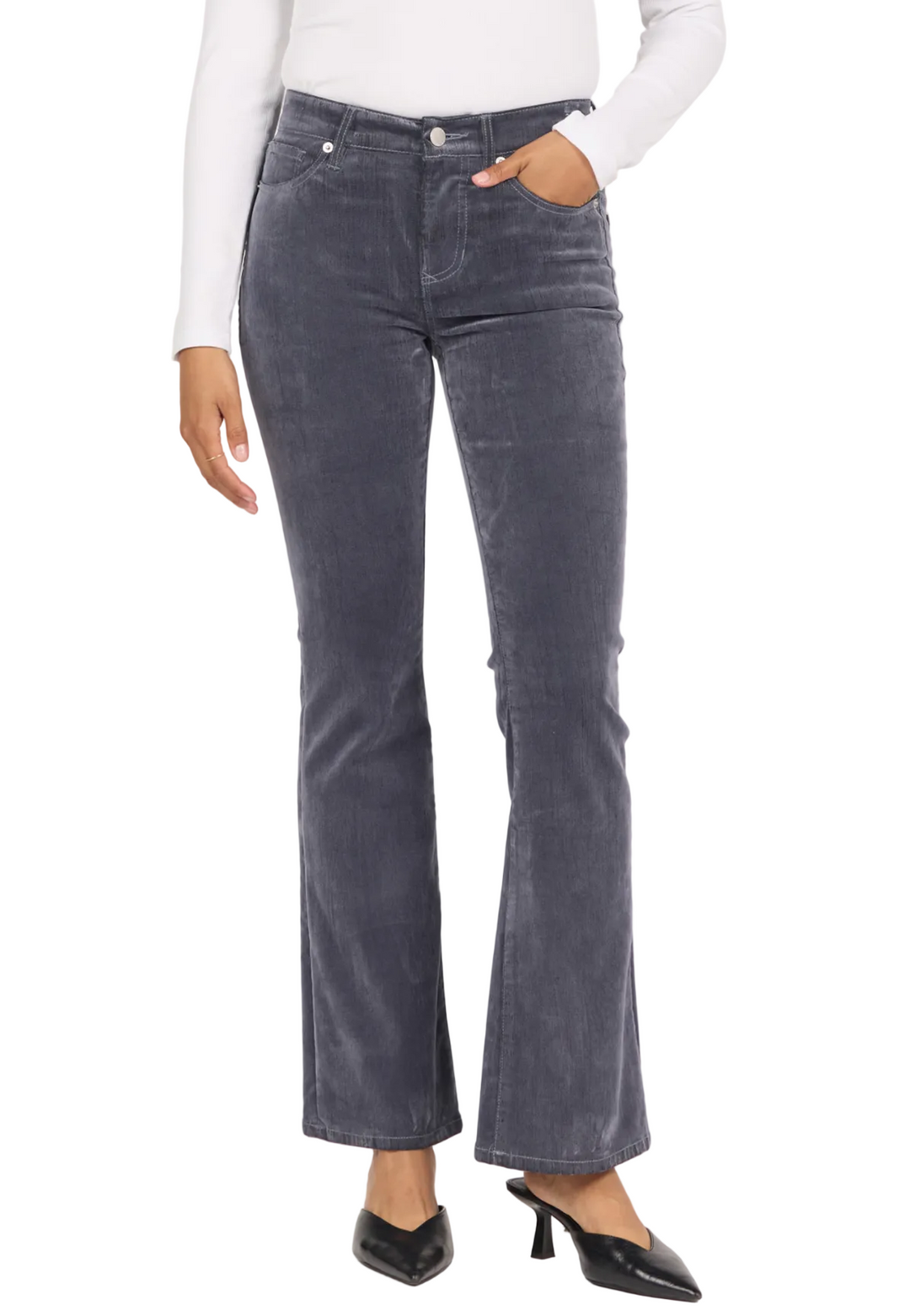 A model wearing a pair of dark gray corduroy flare jeans, styled with a white long-sleeve top and black pointed-toe mule heels, against a plain white studio background.