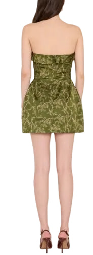 The Avalee Skort Romper in christina print, a trailing floral vine on rich olive green. Strapless satin mini with built-in shorts under a tea-cup skirt. Fold over flap detail at neckline and belt with bow detail at waist. Invisible zipper at center back and fully lined throughout.