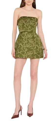 The Avalee Skort Romper in christina print, a trailing floral vine on rich olive green. Strapless satin mini with built-in shorts under a tea-cup skirt. Fold over flap detail at neckline and belt with bow detail at waist. Invisible zipper at center back and fully lined throughout.