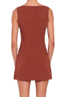 The Ines Romper in harvest, a warm reddish brown. Sleeveless boat-neck mini with high side slits exposing built-in shorts. A tailored and bra friendly cut in a medium-weight fabric, with invisible zipper at center back and lined throughout.