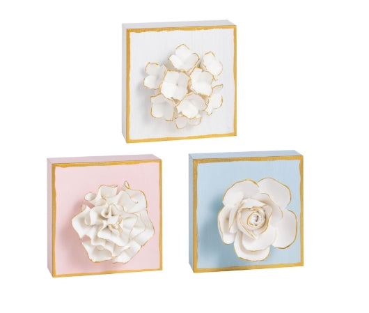 Hand-painted wooden block features dimensional plaster life-like flower.