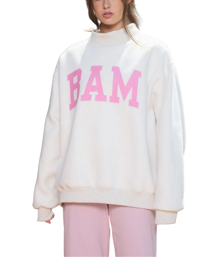 Person wearing a white sweatshirt with &