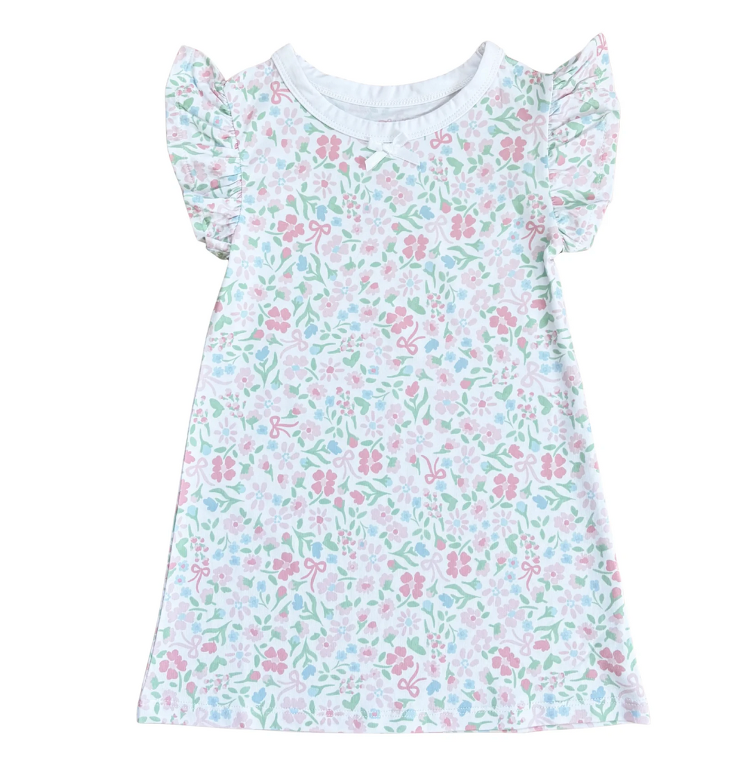A short-sleeve girl's dress with a white base and an all-over floral print in pink, light blue, and mint green. The dress features ruffled cap sleeves, a round neckline, and a flared skirt, shown flat against a solid white background.