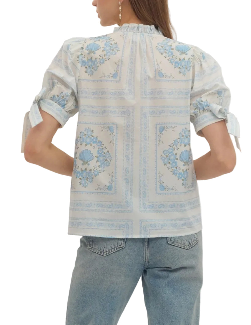 Printed short puff sleeve top featuring ruffle band collar V-neck. Self-tie detail at sleeves. Unlined. Woven. Non-sheer. Lightweight.
