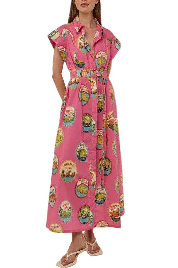 Woman wearing a pink dress with vintage-style labels on a plain background