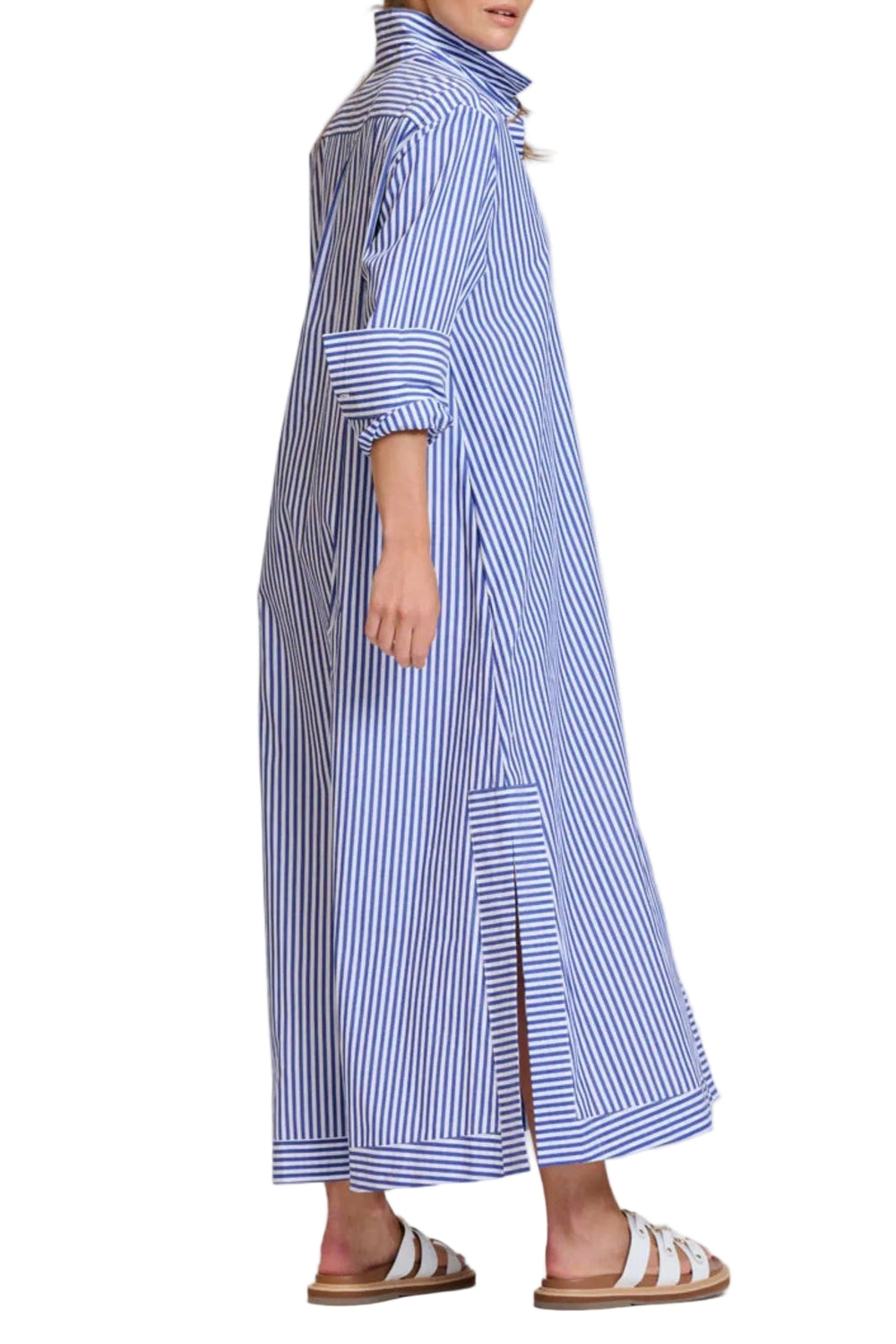 Woman wearing a long blue and white striped dress on a white background