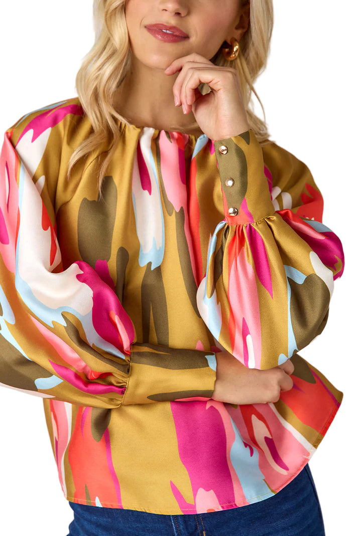 Named after our Elizabeth Street office, the Elizabeth Blouse is a fresh update to our best-selling Claudia Blouse. This effortlessly flowy style features a shirred neckline, full-length balloon sleeves, and gold snap details at the cuffs for a touch of shine.