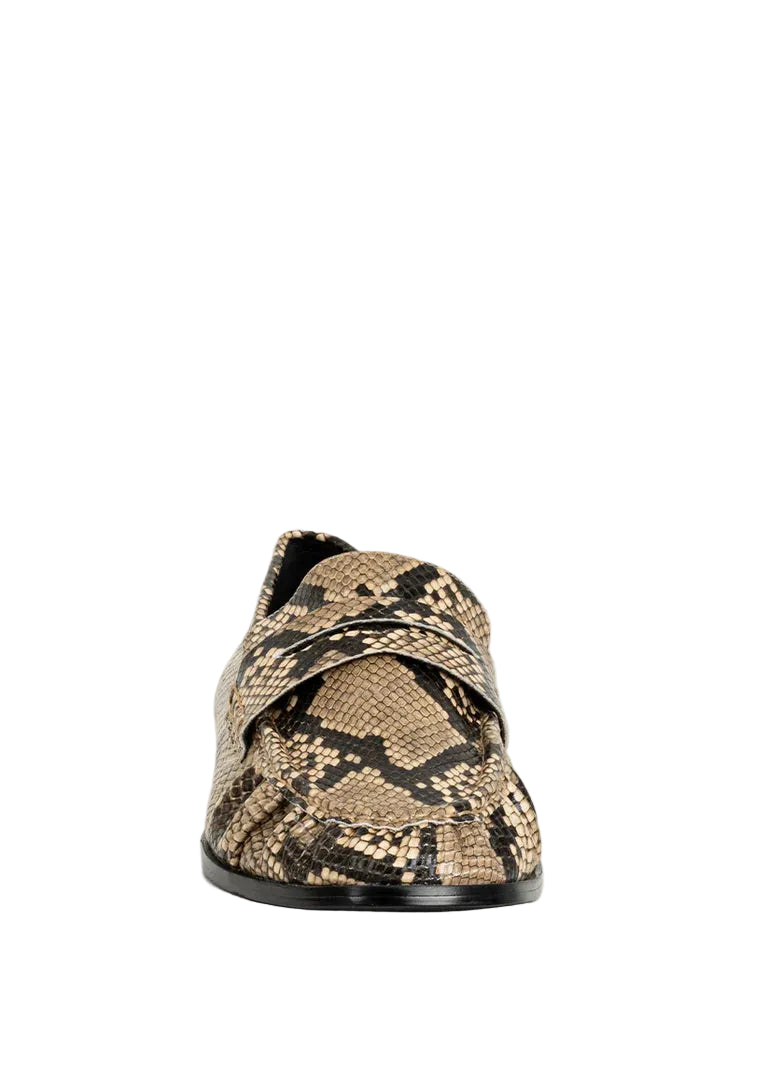 Meet the Tokyo Loafer in a bold snake finish a statement take on a timeless essential. Crafted in a textured leather-like material with an embossed snake pattern, this style brings depth, dimension, and a fashion-forward edge to the classic penny loafer silhouette. The subtle gathered detailing along the vamp enhances its refined look, while the slip-on design and low stacked heel ensure all-day comfort. Effortlessly on trend, Tokyo in Snake is the perfect mix of classic structure and standout style.
