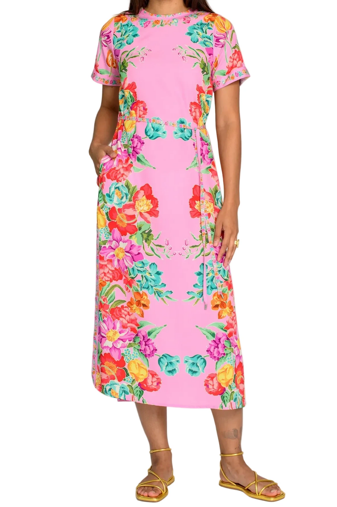 Woman wearing a pink floral dress against a white background