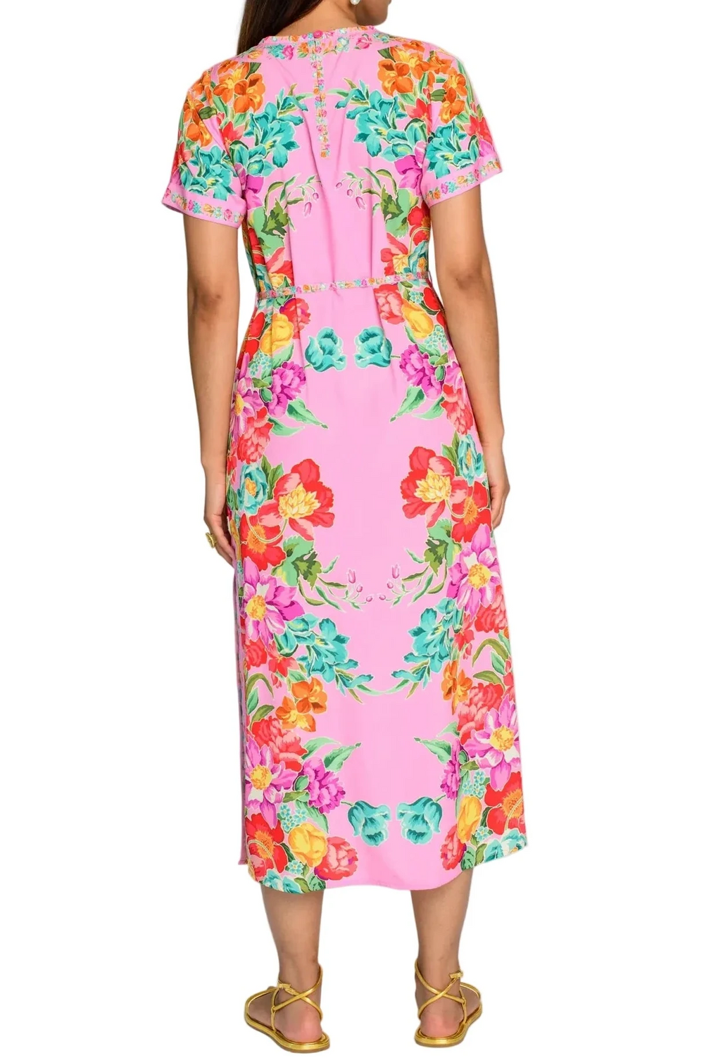 Woman wearing a pink floral dress on a white background