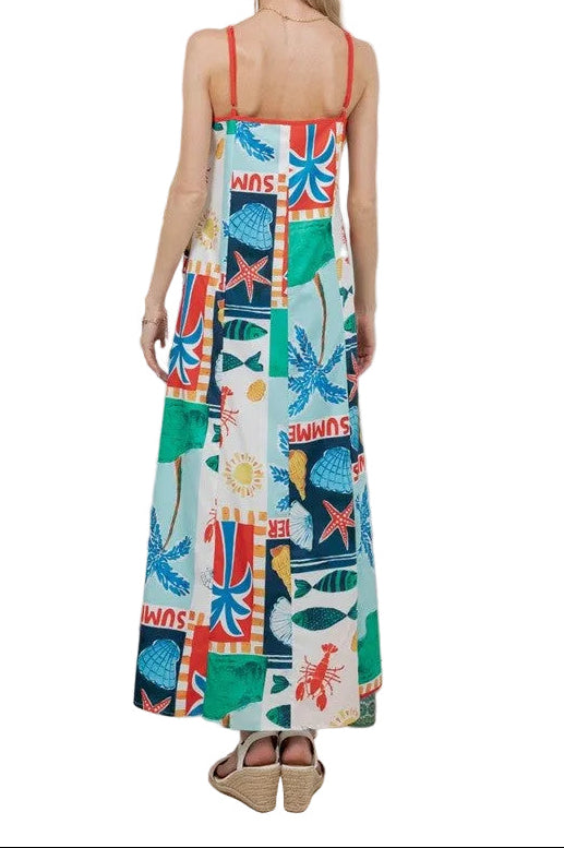 Woman wearing a colorful patterned dress in a minimal indoor setting