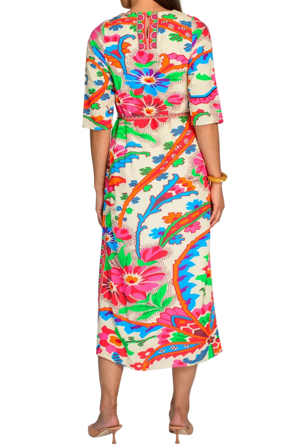Woman wearing a colorful floral dress on a white background