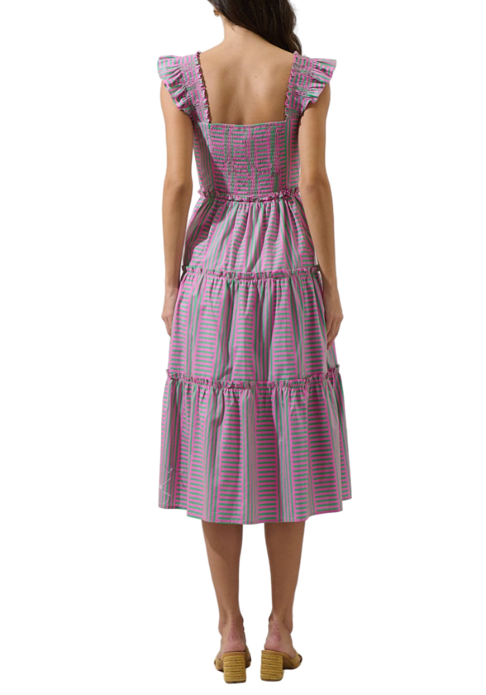 Woman wearing a pink and purple checkered dress on a white background