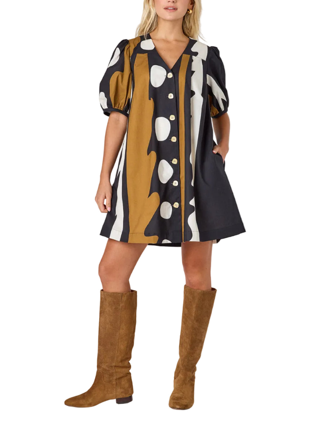 Woman wearing a patterned dress with brown knee-high boots on a white background