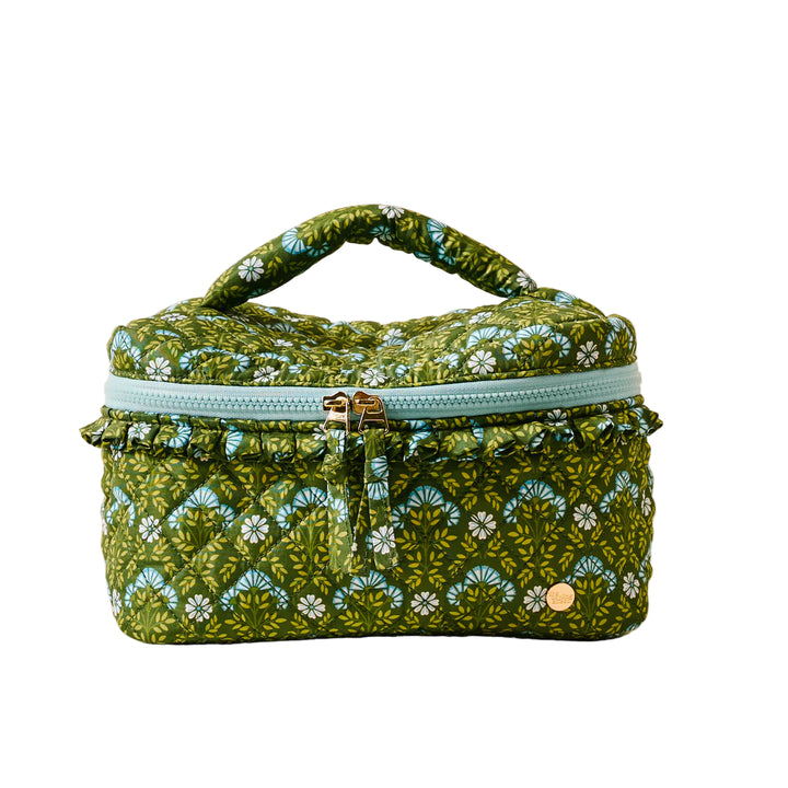 Green floral-patterned fabric bag with a gold zipper on a beige background