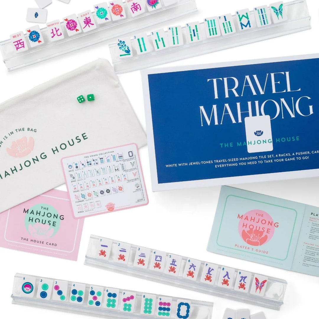 Perfectly sized for on-the-go play, this travel-friendly set includes:
1 set of 160 travel-sized mahjong tiles (36 dots, 36 bams, 36 craks, 8 flowers, 16 winds, 4 white dragons/soaps, 4 green dragons, 4 red dragons, 10 jokers, 6 blanks)
4 racks
1 pusher
1 tile guide
1 player’s guide to mahjong
4 of our House Cards
1 zipper travel bag

Materials:
tiles, racks, and pusher are plastic

Tile dimensions:
36mm x 25mm x 3.6mm

Rack dimensions:
35.8cm x 5.5cm x 2.4cm

Pusher dimensions:
35.8cm x 3cm