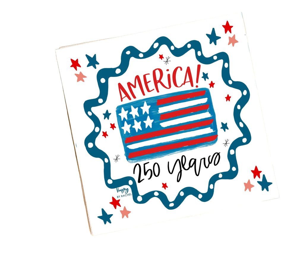 Napkins with American flag design and 'Happy 250th Anniversary' text on a blurred background