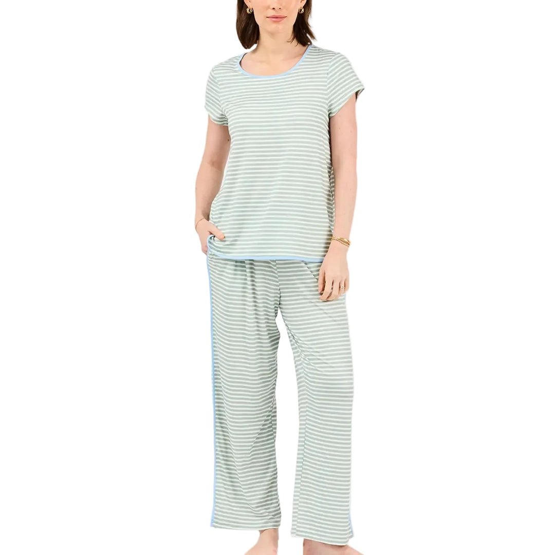 Woman wearing a striped pajama set on a white background