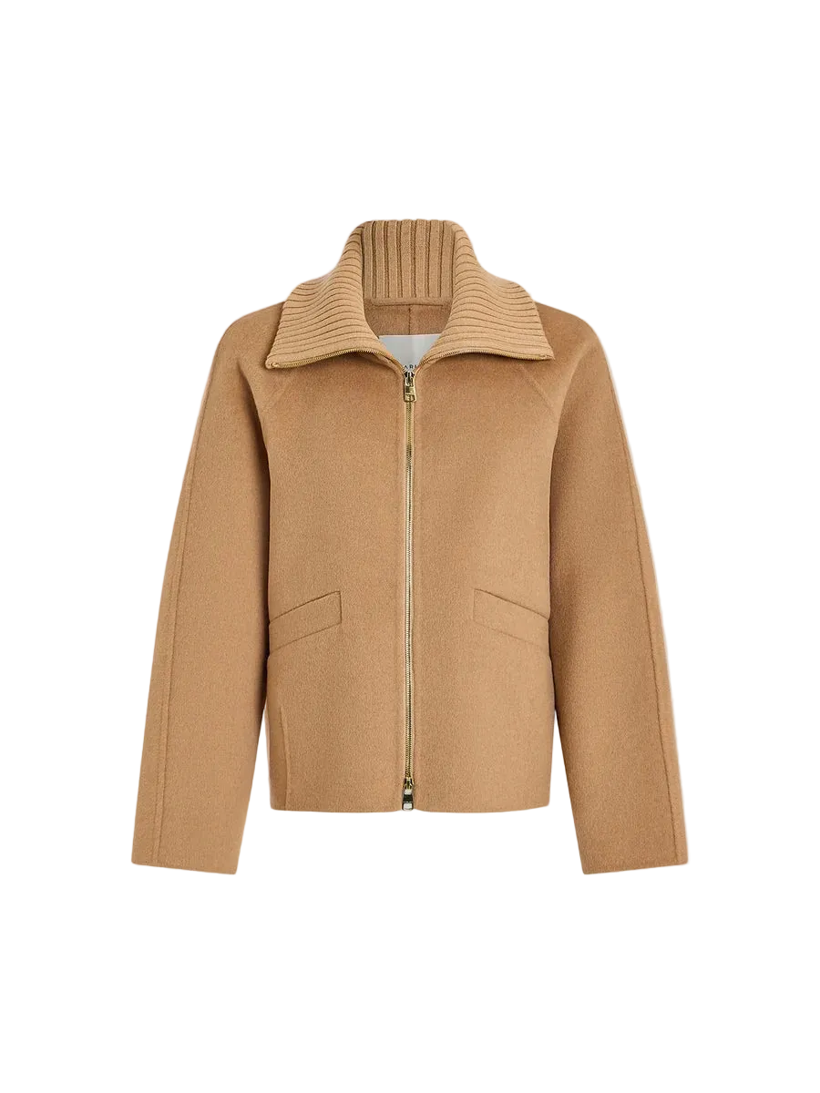 A camel-colored zip-up jacket with a ribbed knit mock neck collar, displayed on a clean, light gray background.