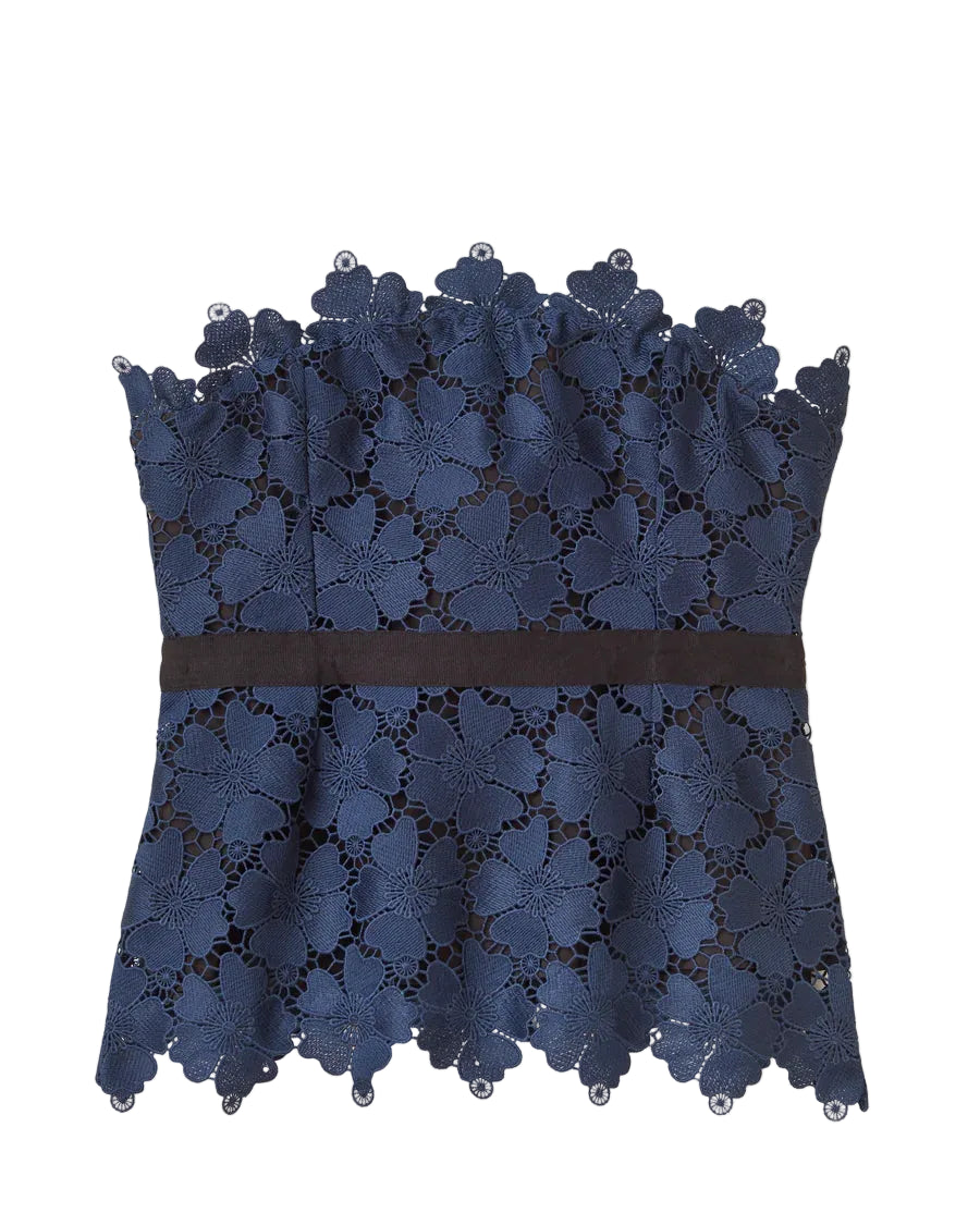 A sculptural edge defines the Romita top, blending sharp structure with intricate lacework for a look that’s made for moments that call for a statement.

Boned peplum bodice shapes and defines the waist
Convertible design with detachable grosgrain straps allows strapless styling
Contrast grosgrain waistband and scalloped lace detailing add dimension