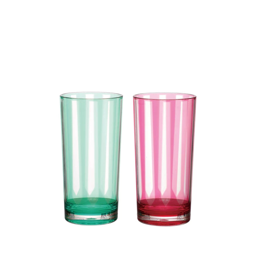 Two colorful glass tumblers, one green and one pink, on a white background.