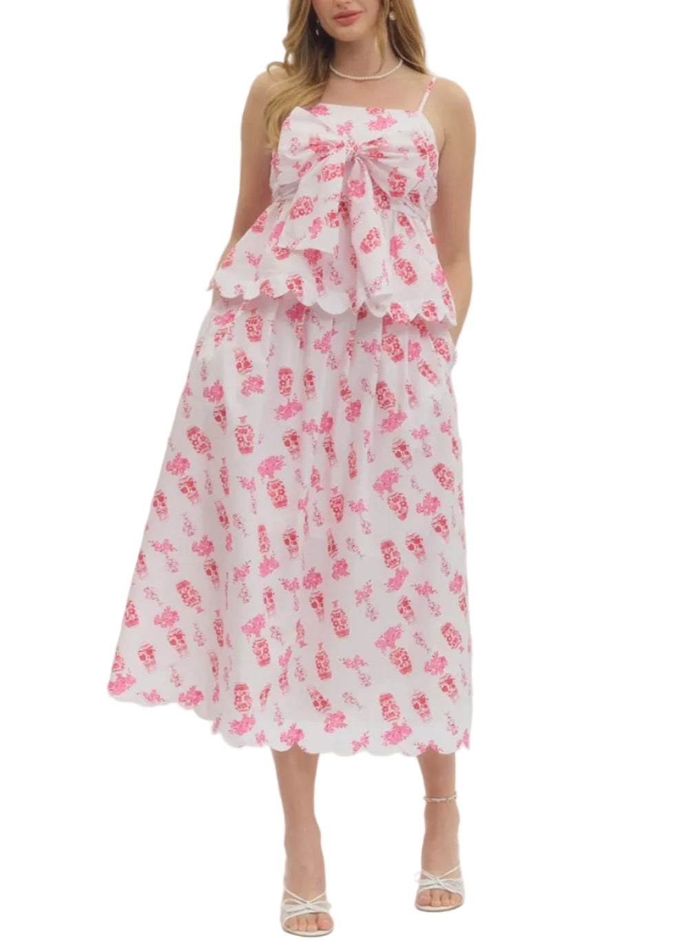 Printed sleeveless top featuring self-tie bow detail at front. Adjustable shoulder straps. Smocked back panel. Scallop accent trim at hem. Lined. Woven. Non-sheer. Lightweight